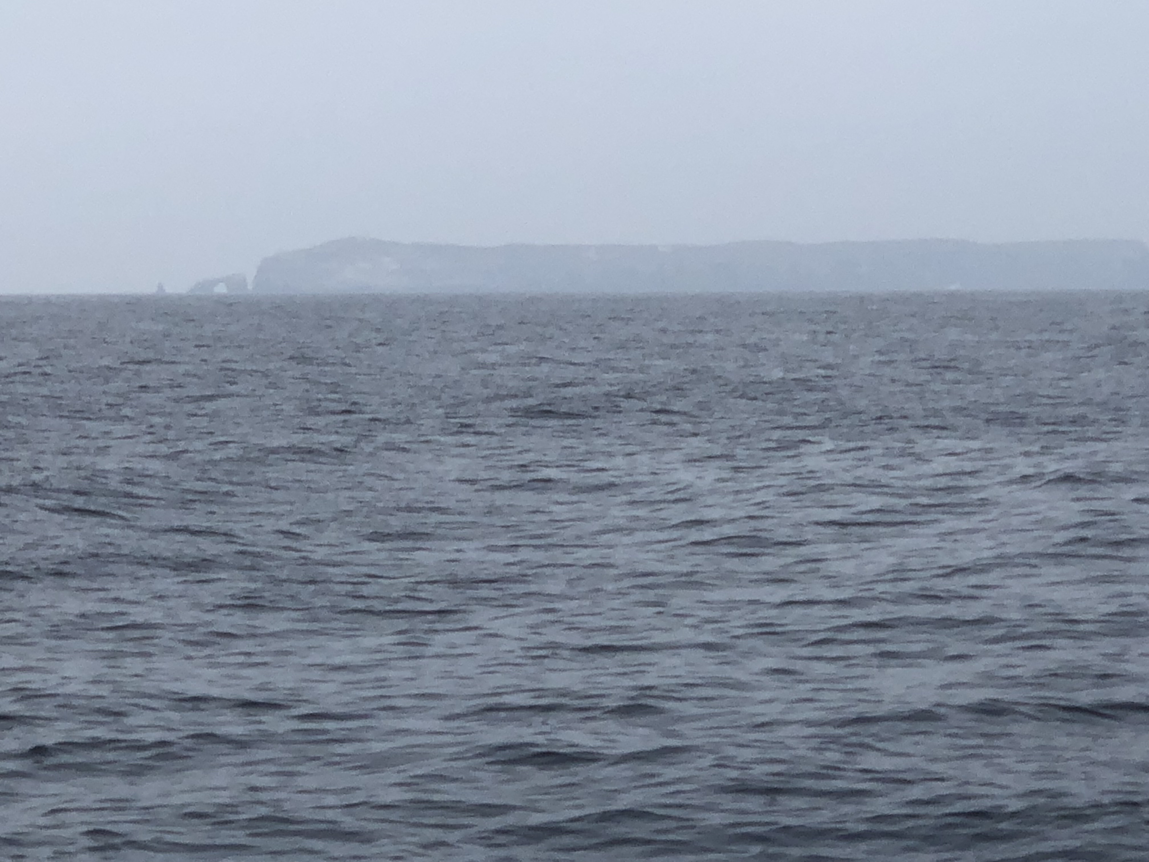 Anacapa Arch barely visible through the marine layer fog